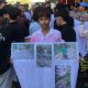 Massa aksi bawa poster berisi foto kondisi jalan yang rusak parah di Pulau Kangean.