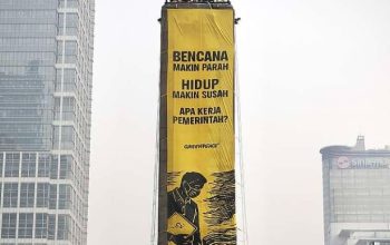 Spanduk raksasa yang dipasang aktivis Greenpeace Indonesia di atas Patung Selamat Datang Bundaran HI, Jakarta Pusat. [Foto: Greenpeace Indonesia]